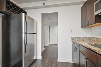an empty kitchen with stainless steel appliances and granite counter tops